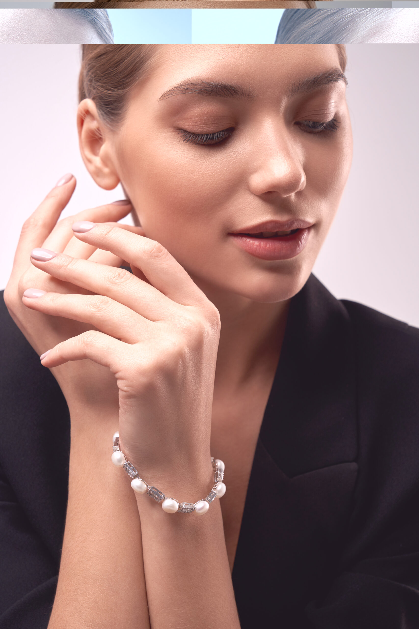 young brunette model demonstrating jewelry.